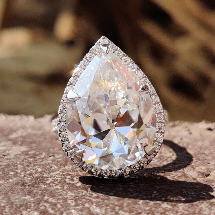 Pear old European cut moissanite ring with double side halo in white gold.
