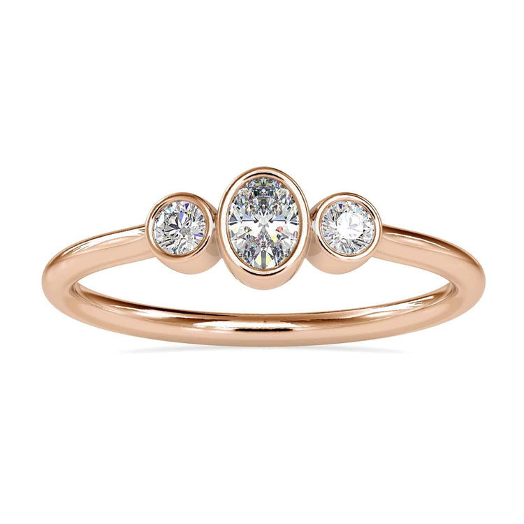 Three stone oval engagement ring with round side diamonds in bezel setting.
