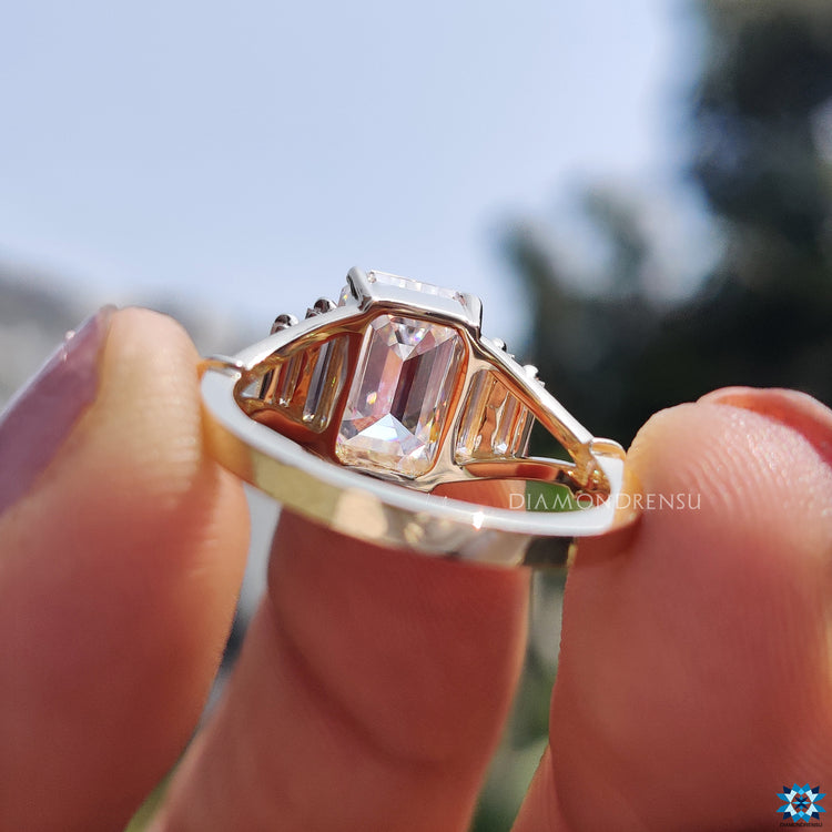 Yellow gold engagement ring with five moissanite stones.
