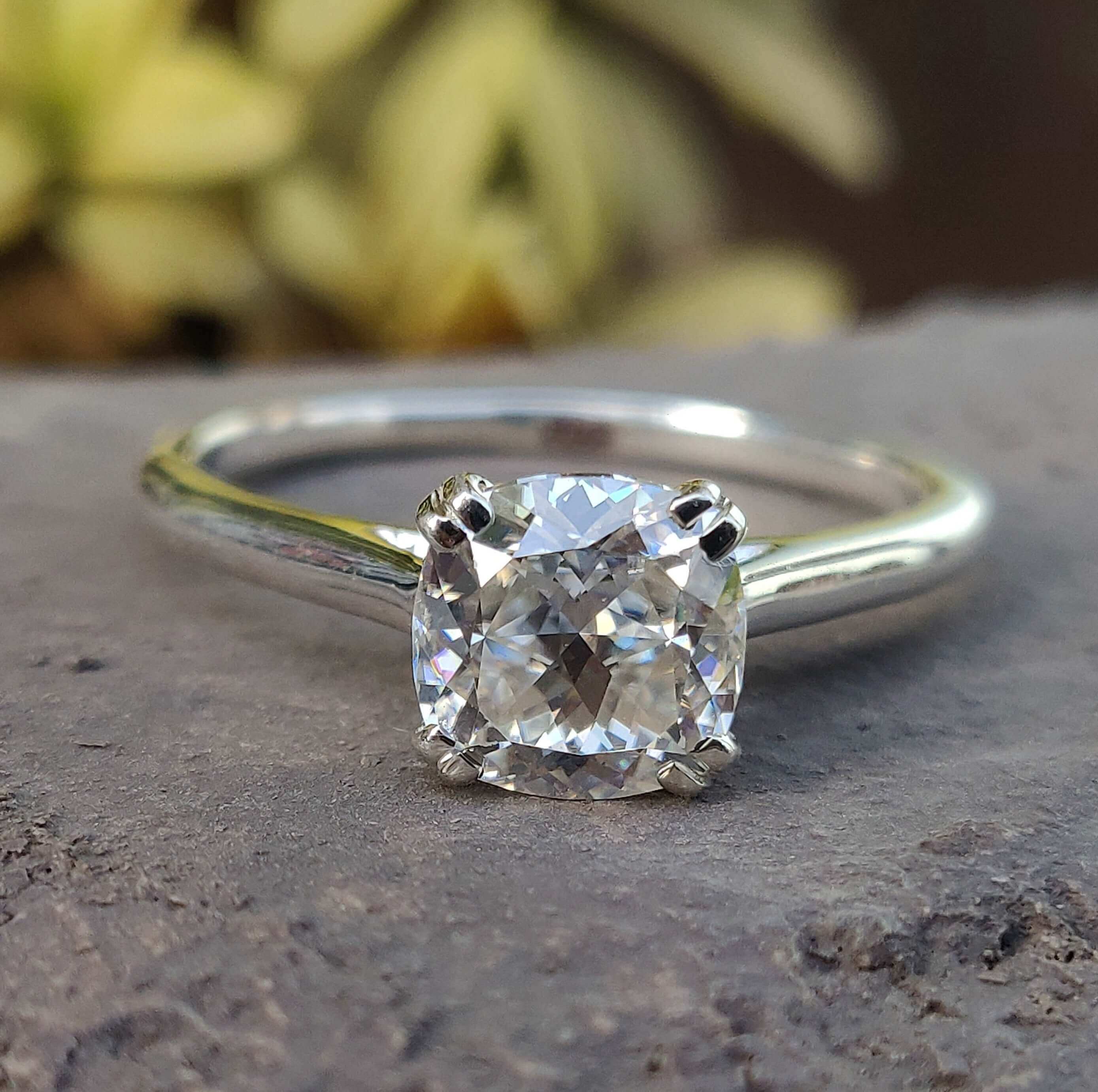 Cushion cut ring in cathedral setting with double prong setting
