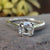 Cushion cut ring in cathedral setting with double prong setting
