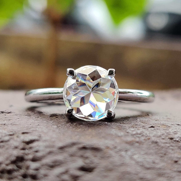Round rose cut moissanite engagement ring in white gold.

