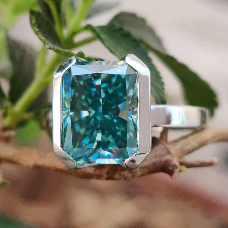 Half bezel radiant cut moissanite engagement ring in white gold.
