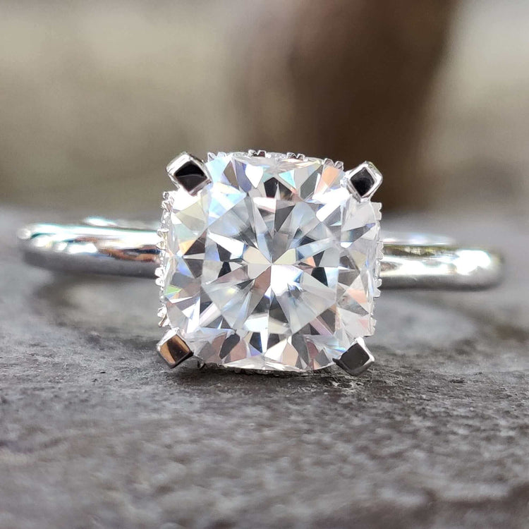 Cushion cut moissanite engagement ring in white gold.
