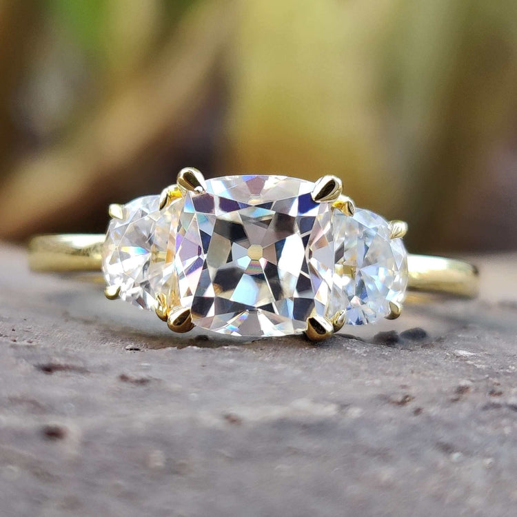 Cushion old European cut moissanite ring in yellow gold.
