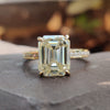 Hidden halo engagement ring with emerald cut light yellow moissanite centre.
