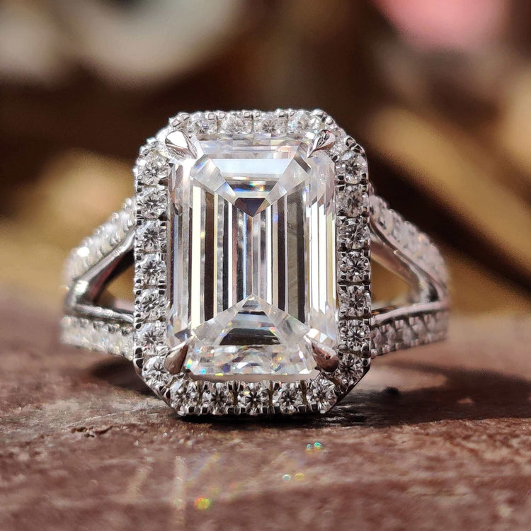 Emerald cut moissanite ring with split shank design.
