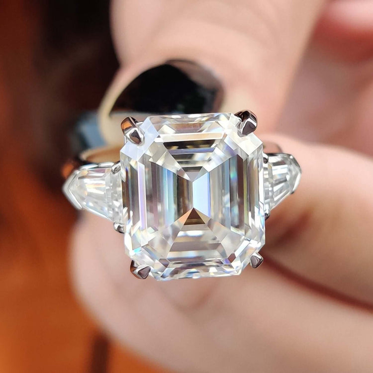 Emerald cut moissanite engagement ring with tapered bullet side stones.
