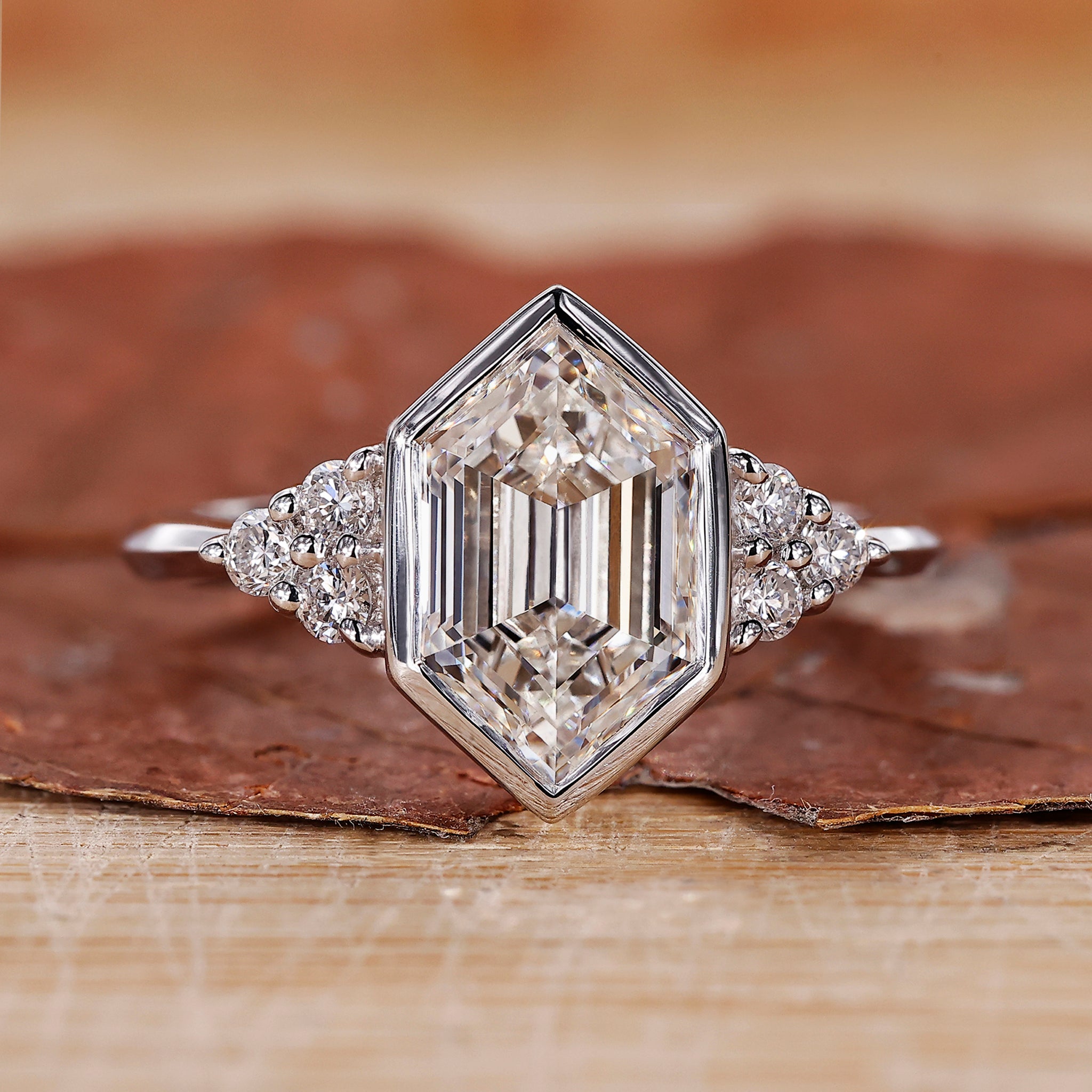 Engagement ring with bezel setting and hexagon step cut diamond.
