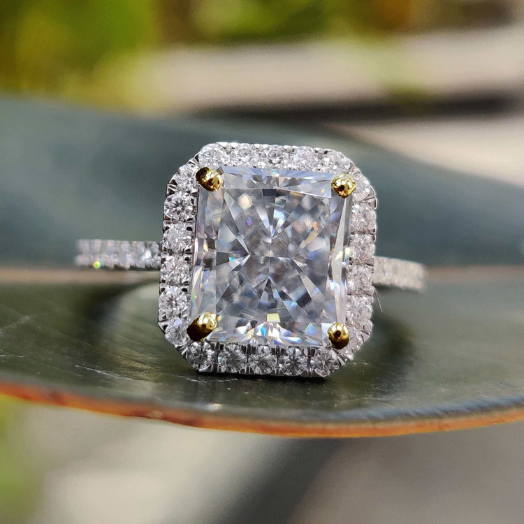 Gray radiant cut moissanite engagement ring with halo design.

