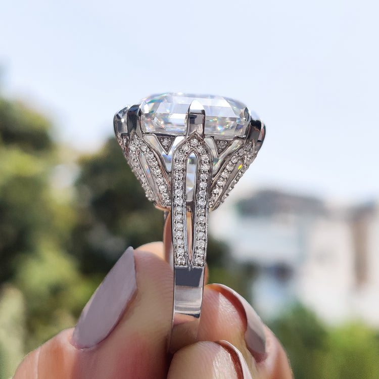 Asscher cut engagement ring with split shank pave band and claws.
