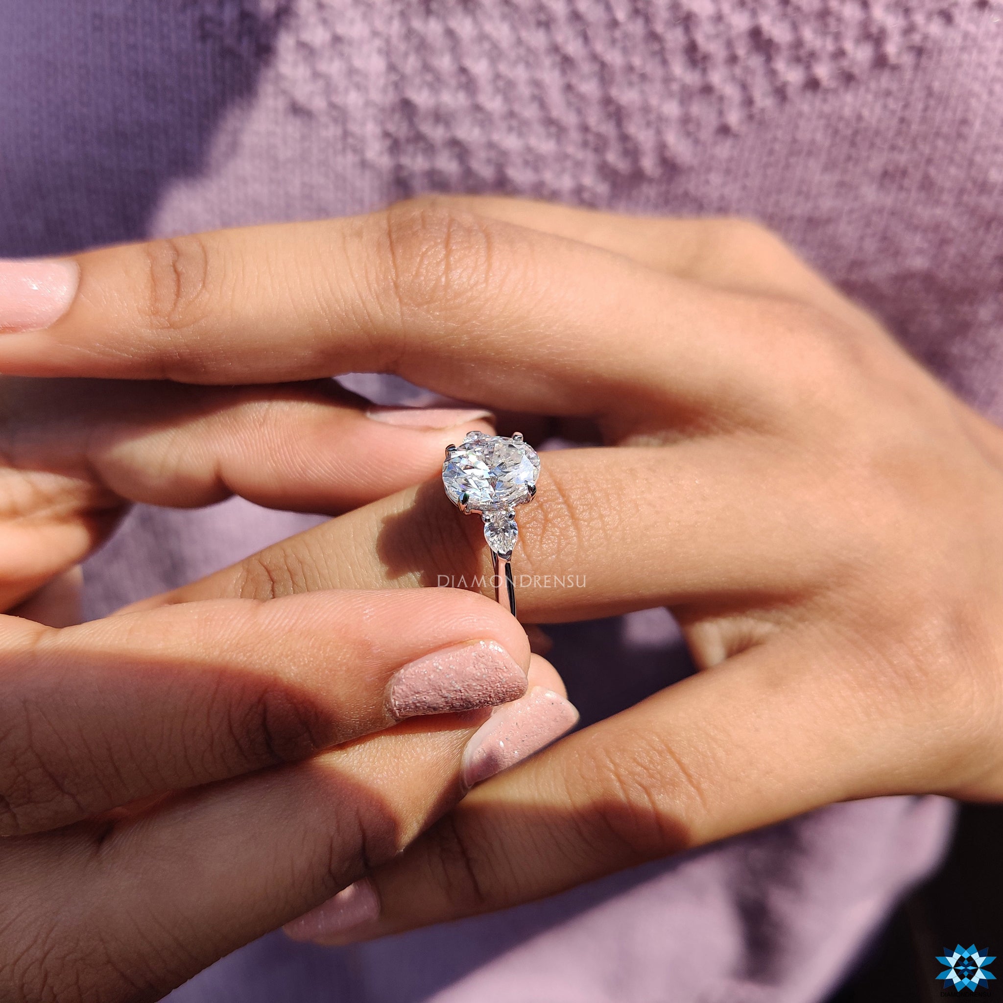 Buy engagement ring with three moissanite stones in white gold.
