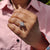 Half halo ring with kite cut centre stone and round cut side stones.
