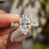 Dutch marquise ring with round cut hidden halo in white gold.
