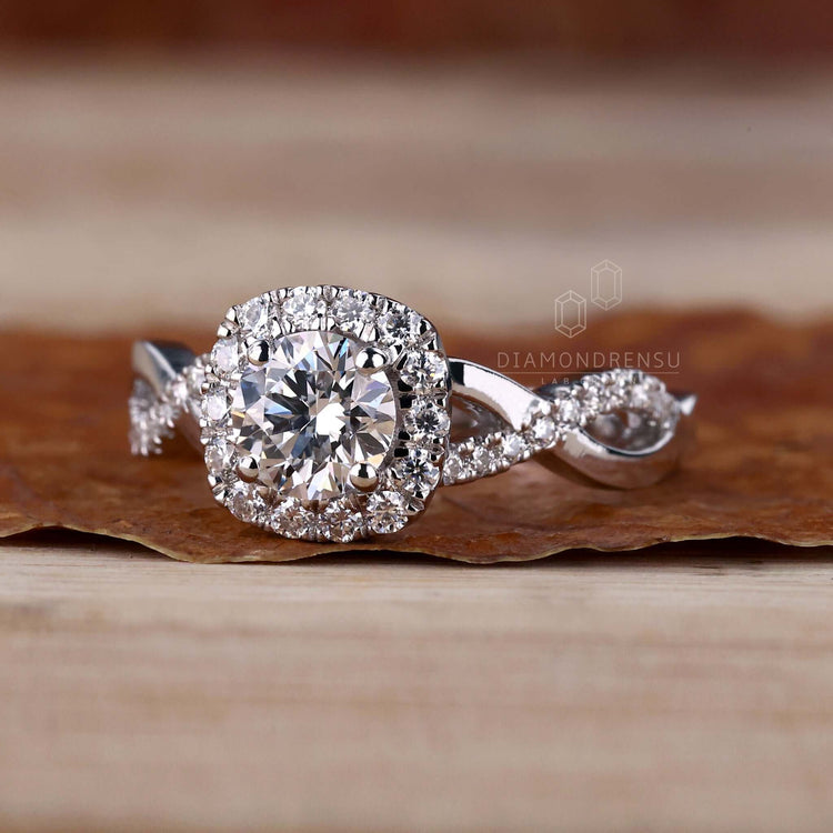 Round diamond ring with halo rings and pave diamond accents, ideal for engagements or special occasions.
