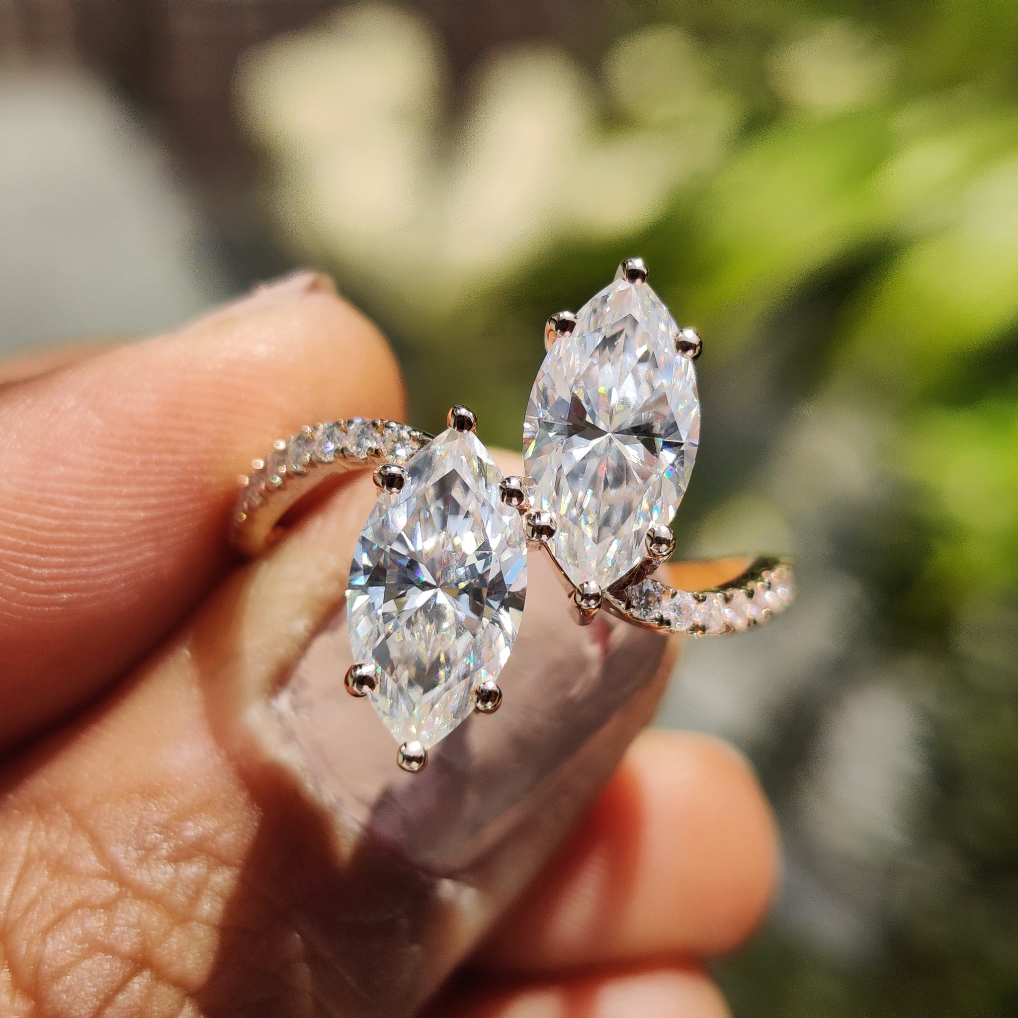 2 stone engagement ring with marquise cut moissanite and wave pave setting.
