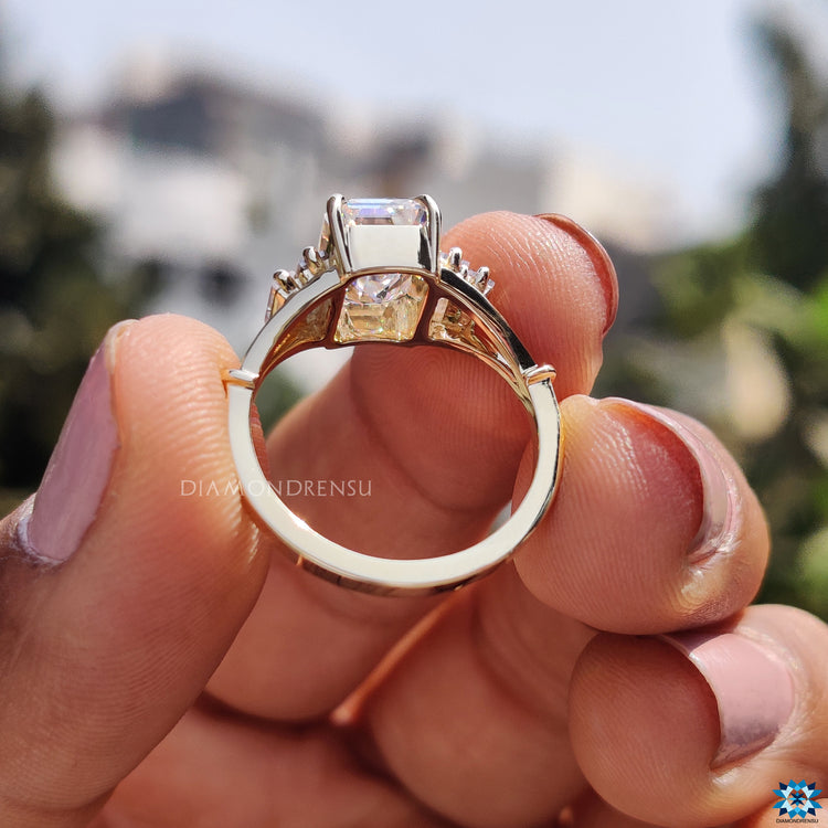 Split shank yellow gold moissanite engagement ring.
