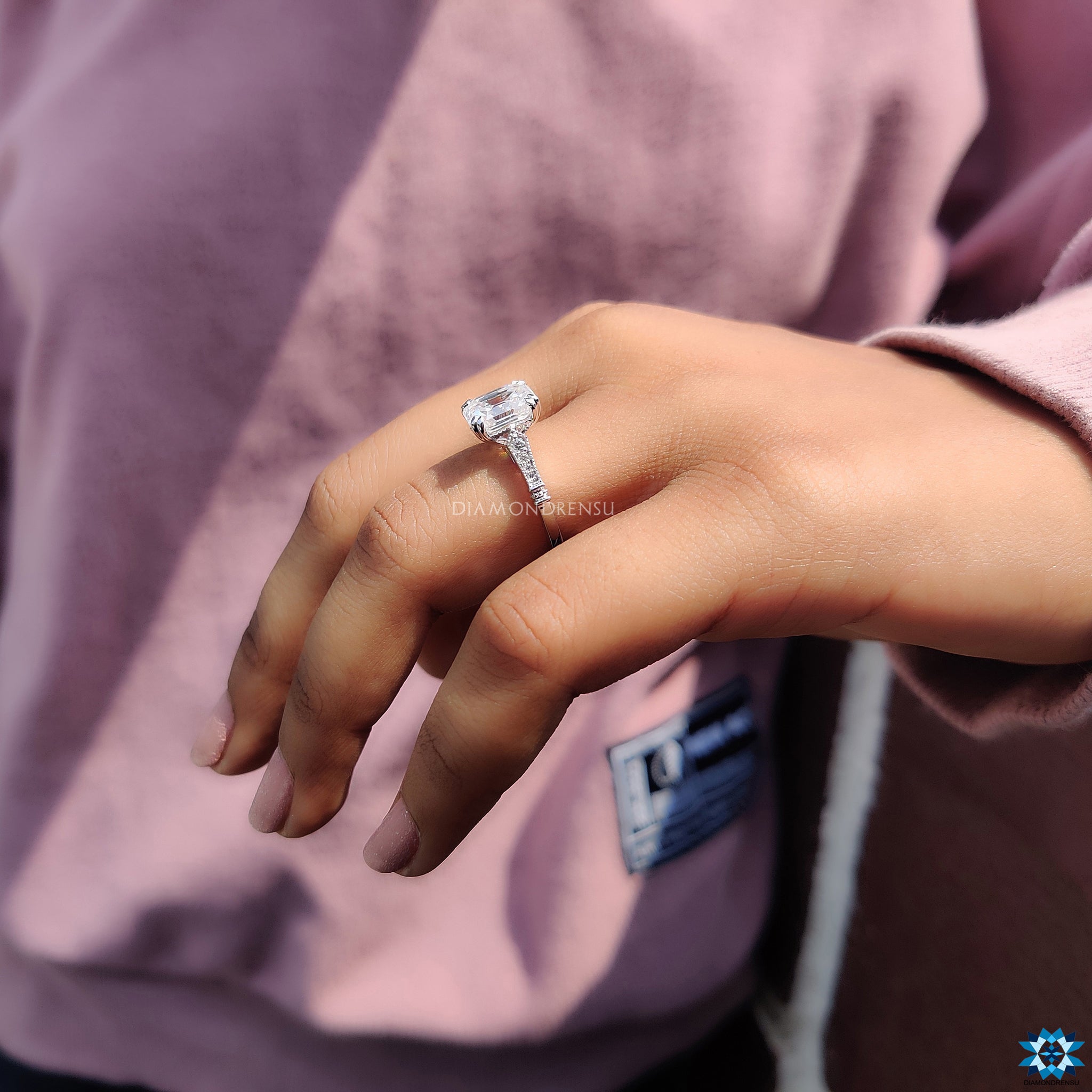 White gold moissanite ring with milgrain edges and cathedral mount.
