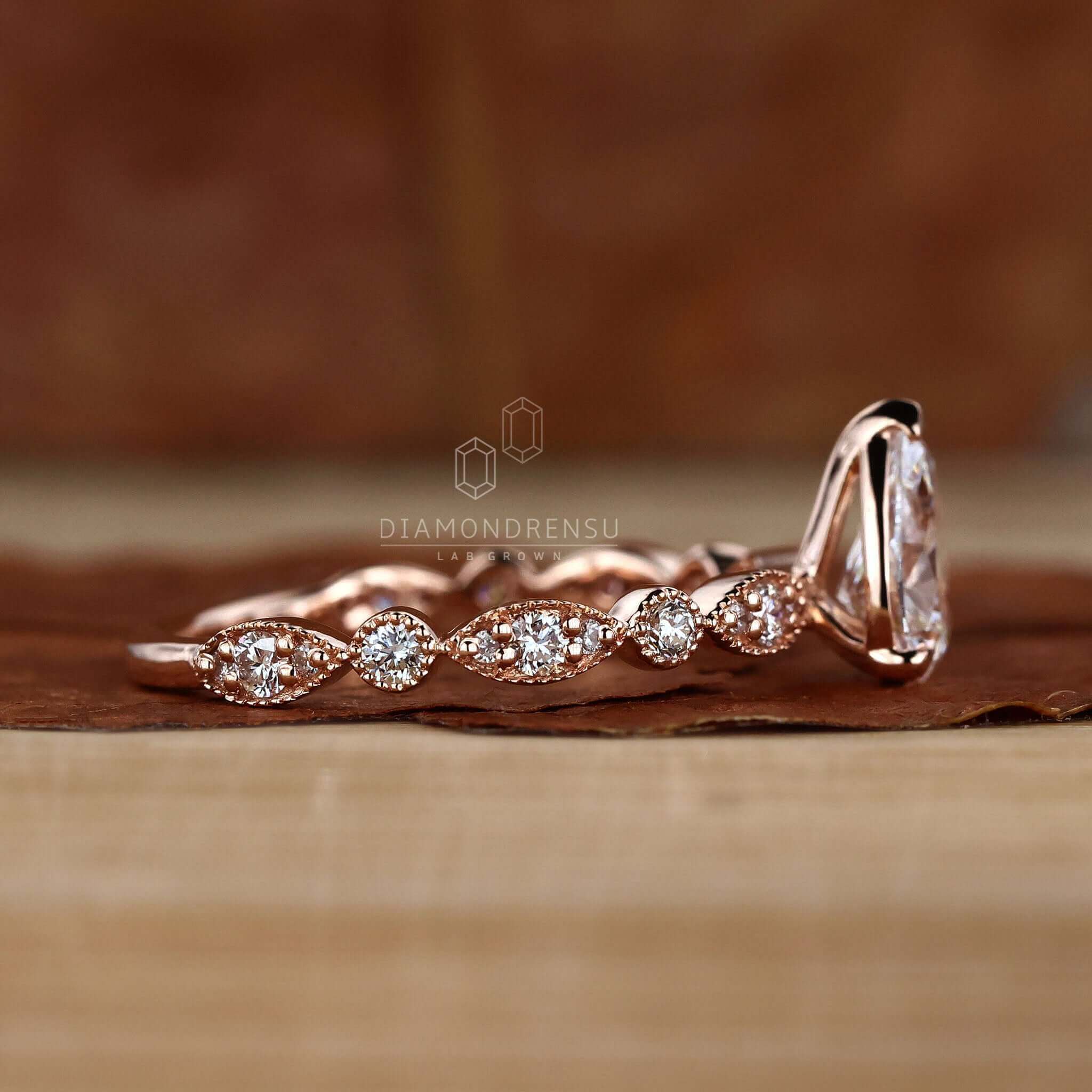 Pear diamond ring paired with a milgrain wedding ring for a vintage-inspired design.
