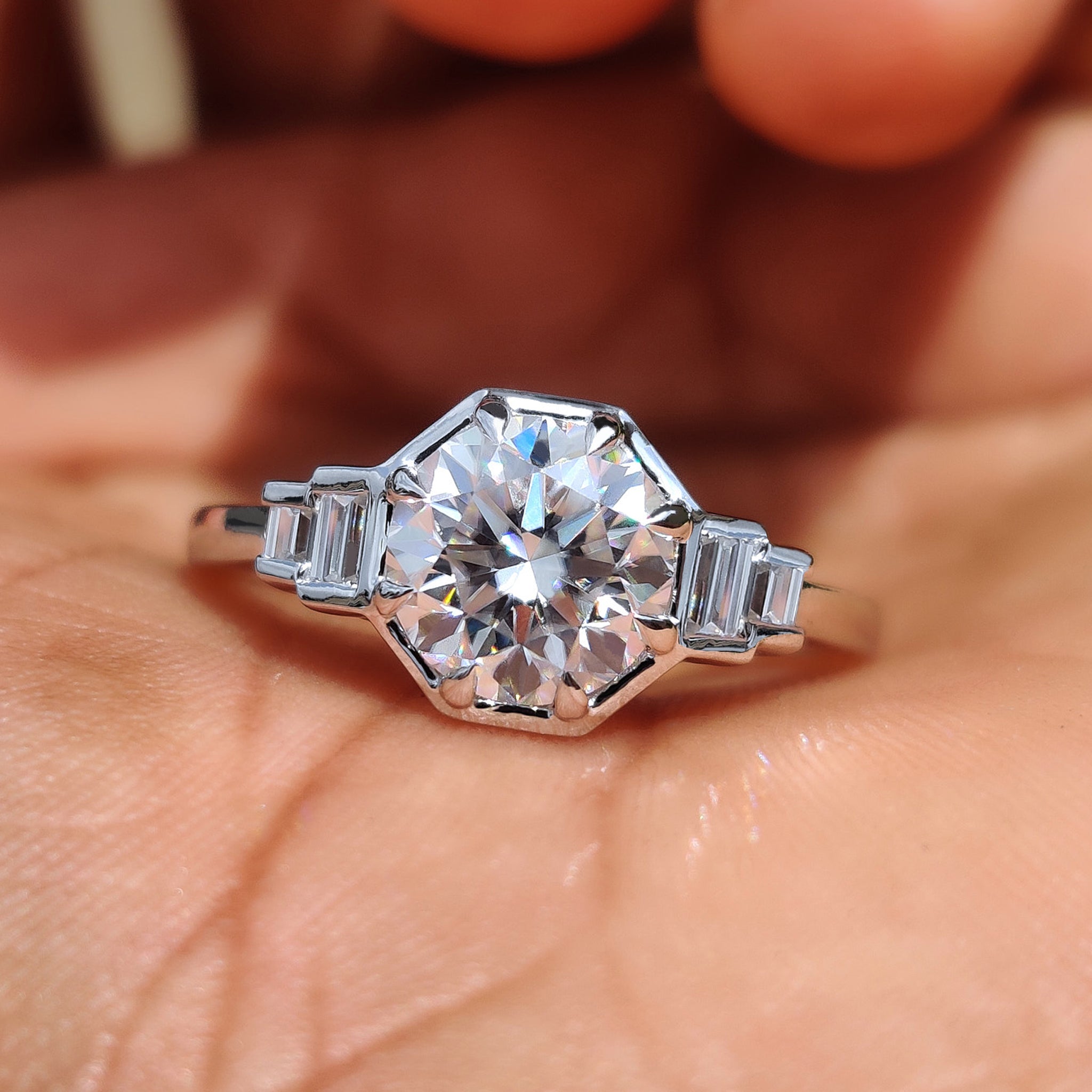 5 stone engagement ring with round moissanite centre and baguette side stones.
