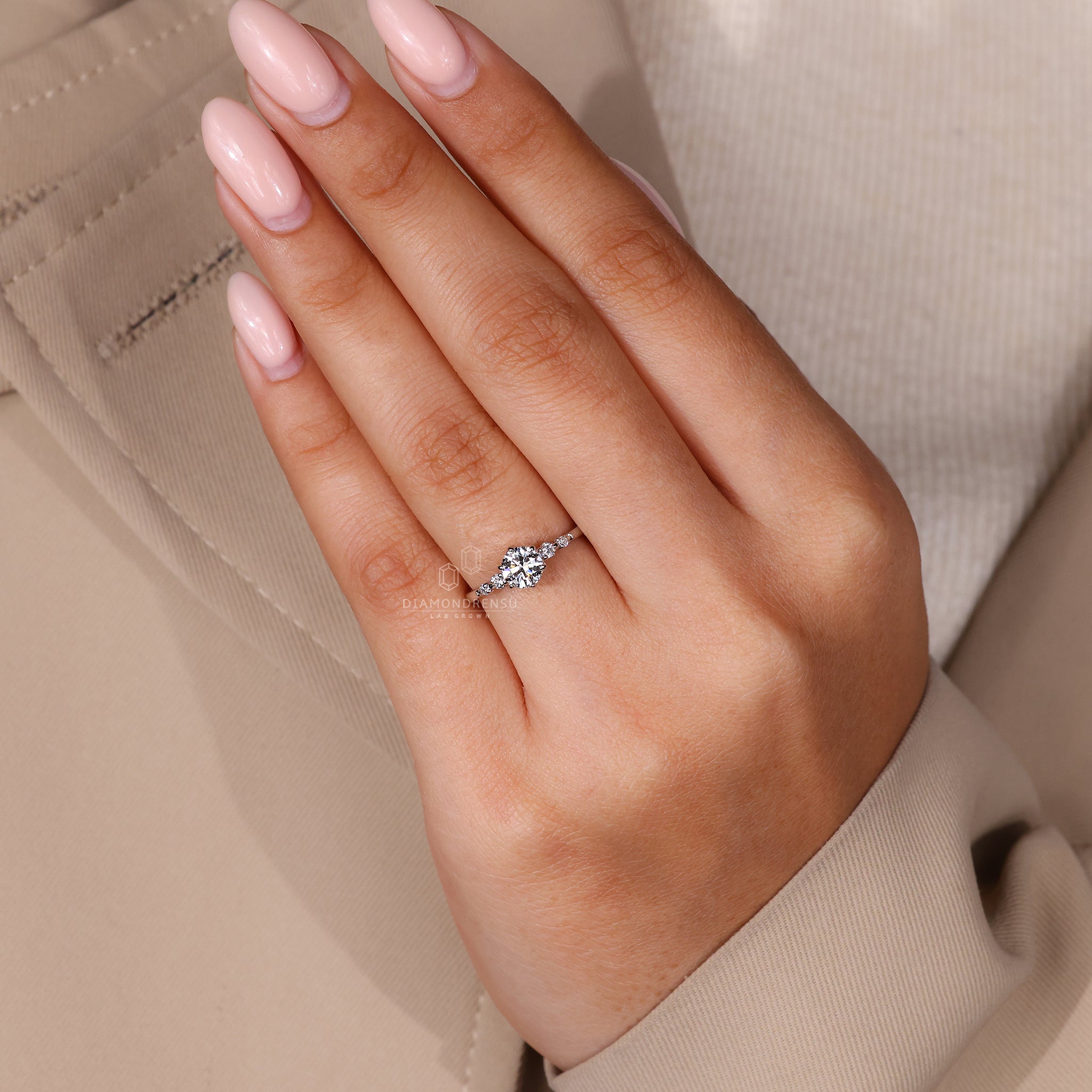 UK engagement ring with round diamond side stone.
