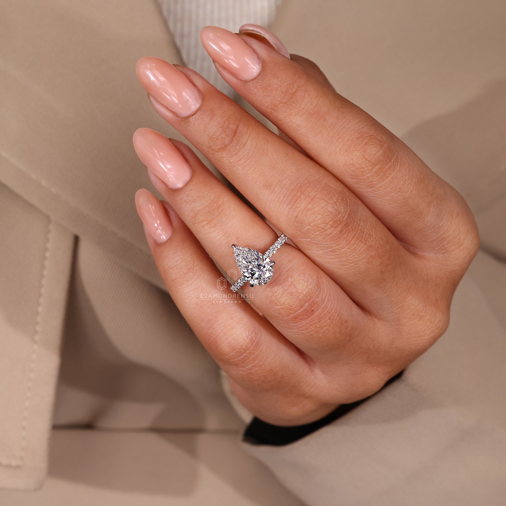 UK engagement ring crafted in pear shaped diamond ring.
