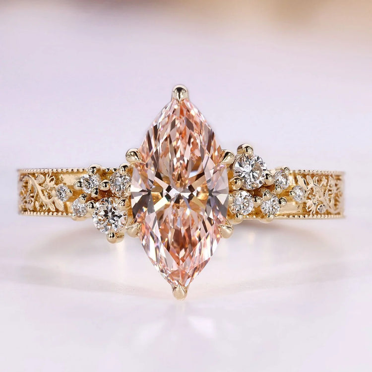 Marquise cut diamond ring with pink centre diamond.