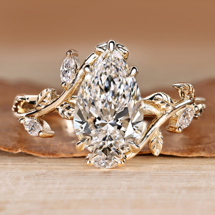 Pear cut diamond ring with marquise side stones.