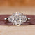 3 stone oval engagement ring with half moon side stones.
