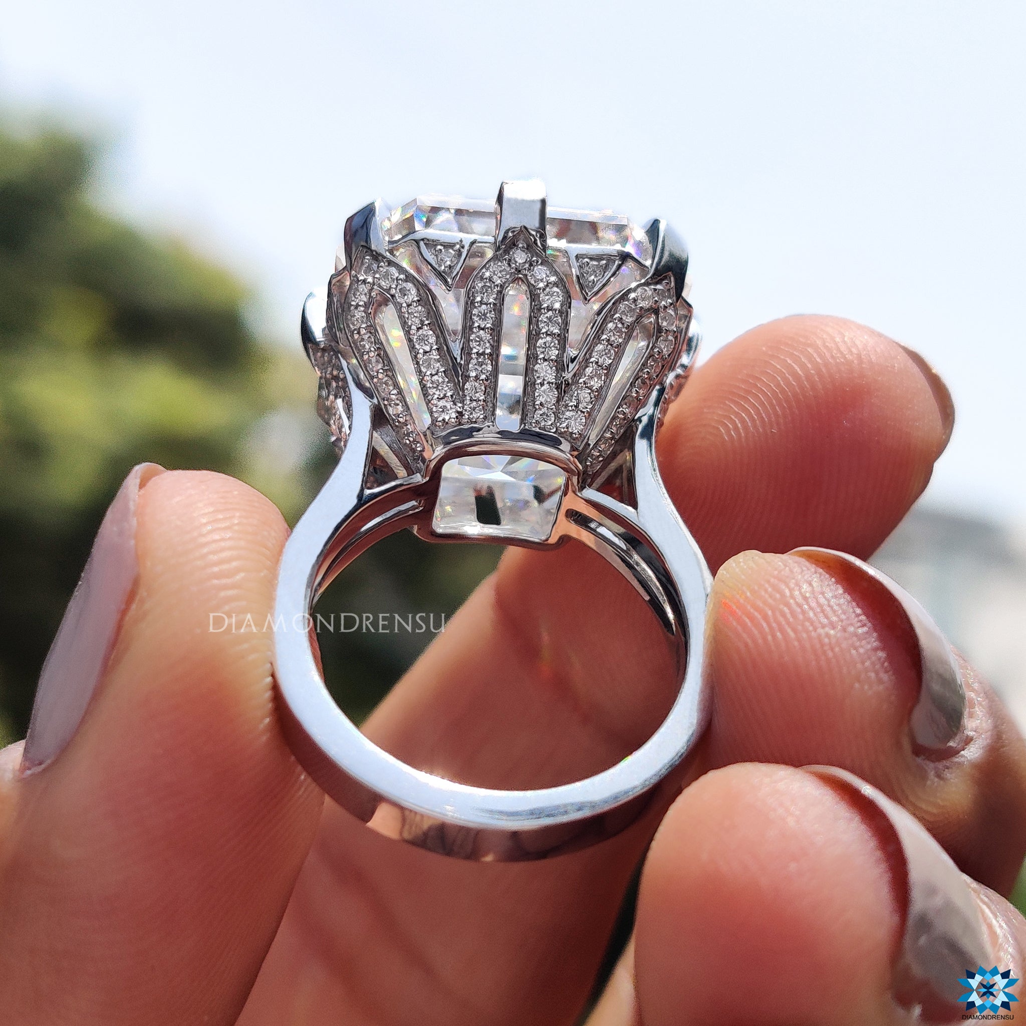 Cathedral setting engagement ring with crown motif and round side stones.
