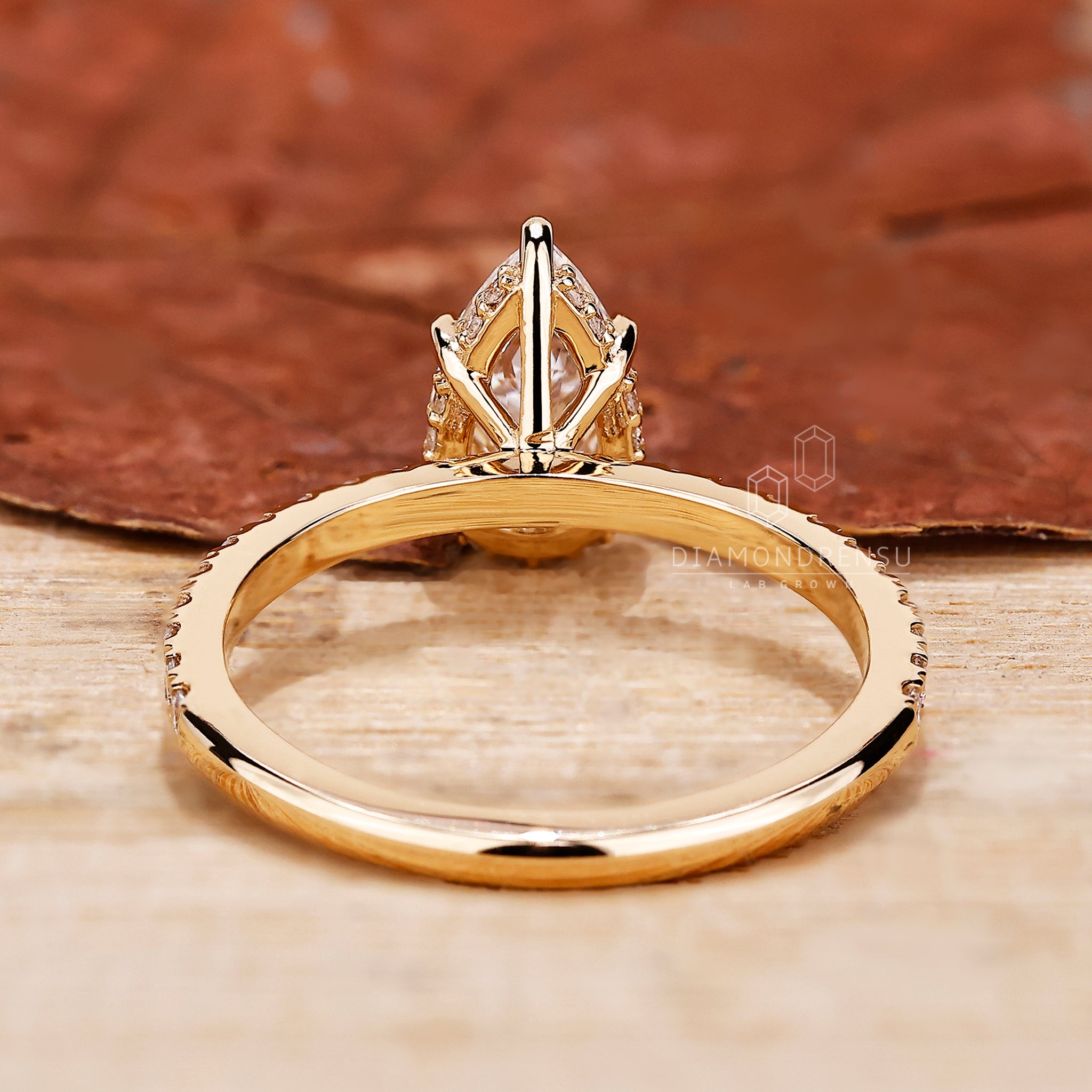 Handmade ring with pave setting and pear cut diamond details.
