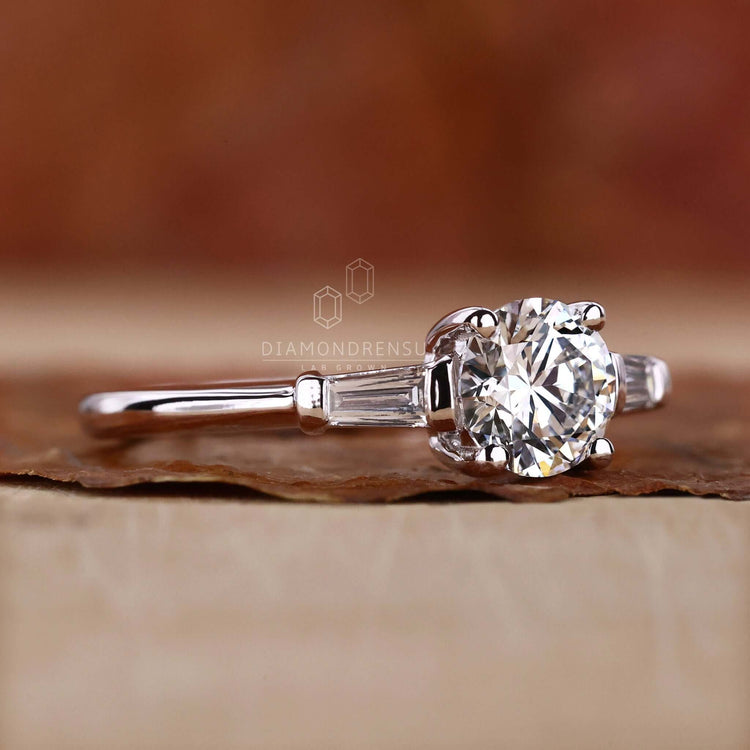 Elegant 3 stone engagement ring with a round diamond and 4 prong setting, perfect for UK engagement occasions.
