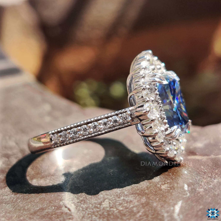 Blue moissanite engagement ring in white gold with prong setting.
