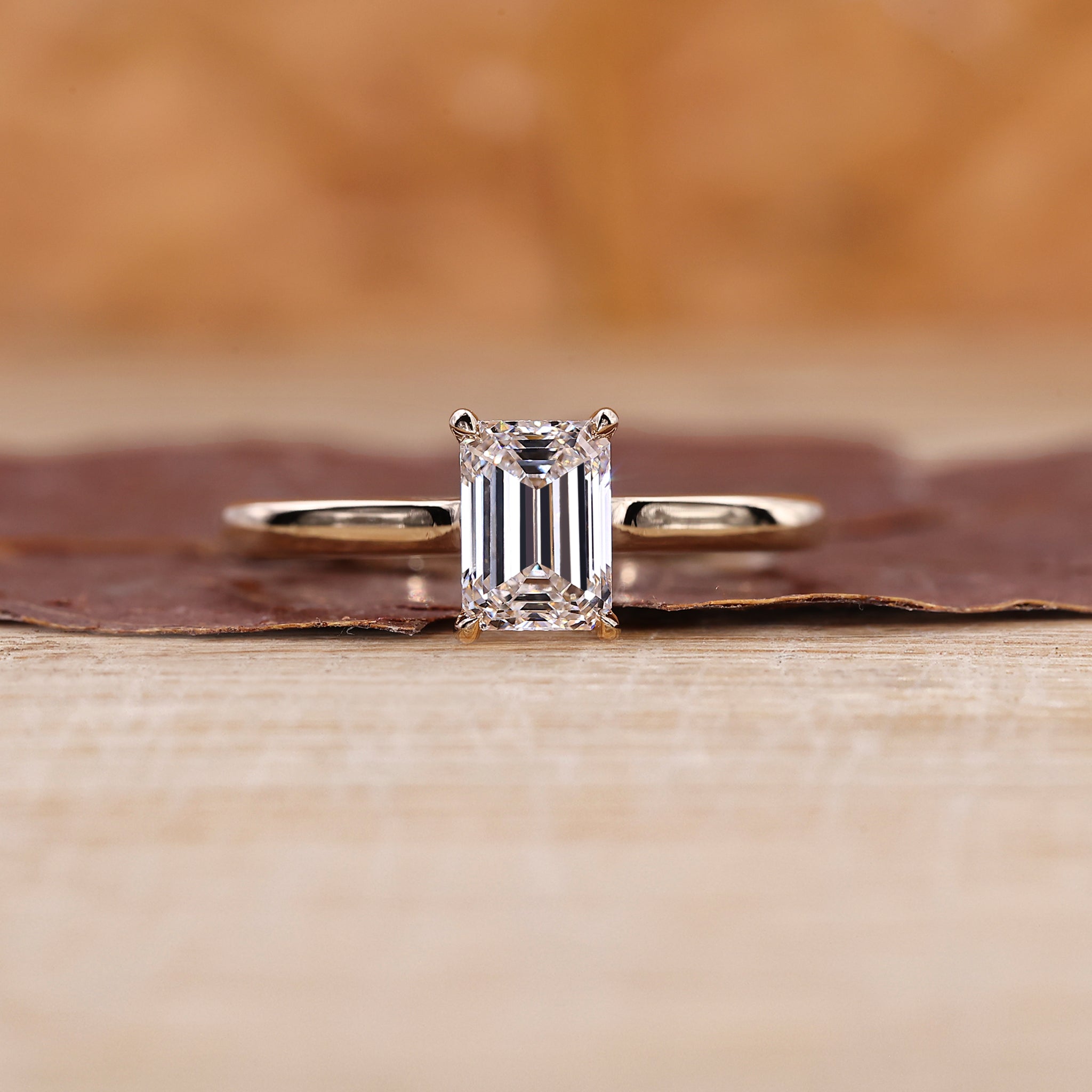 Emerald cut diamond ring with yellow gold band.
