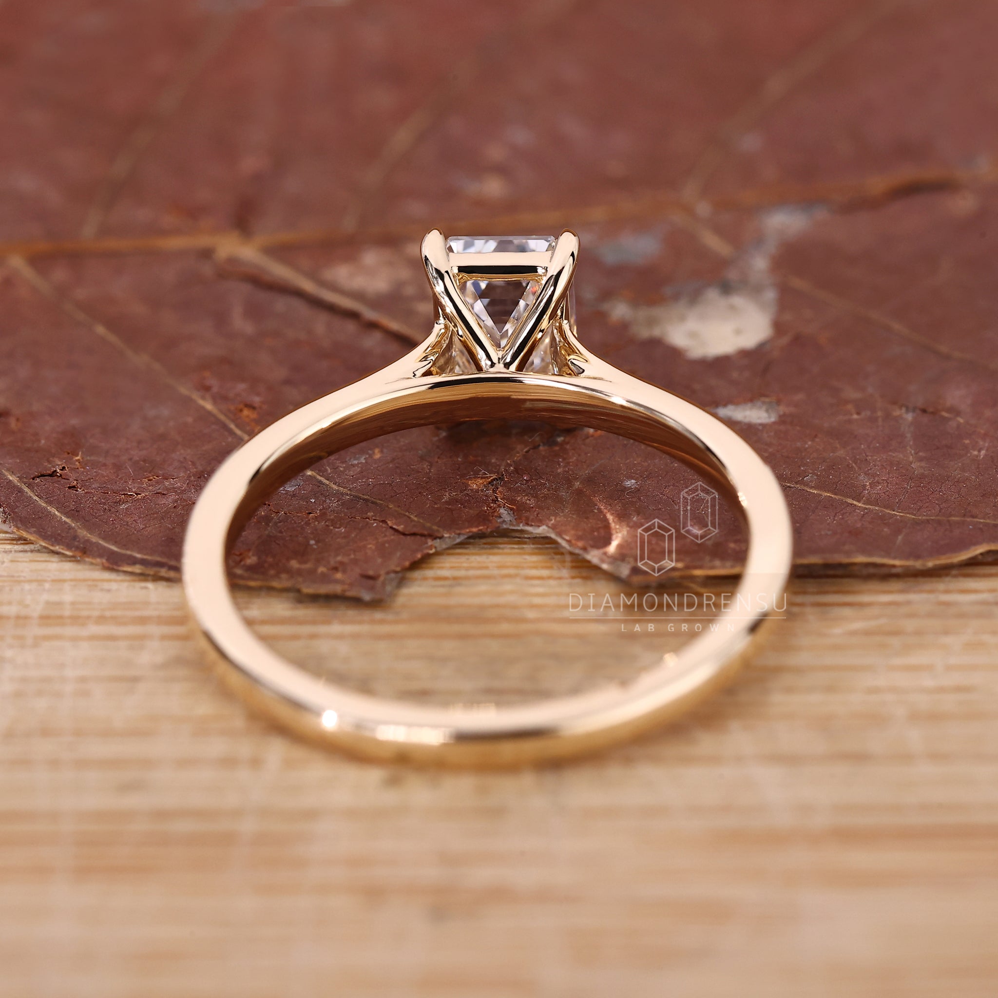 Diamondrensu UK ring featuring emerald cut diamond and cathedral setting.
