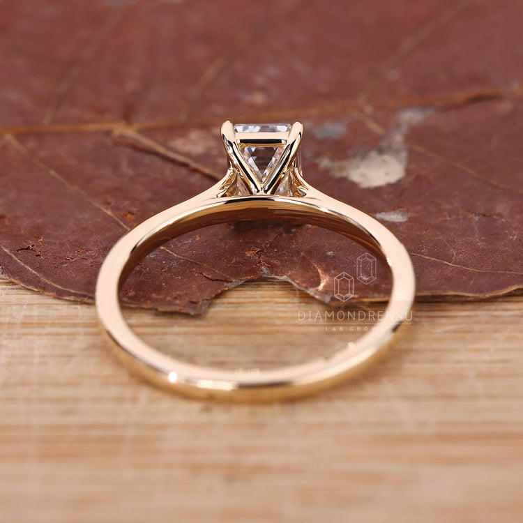 Diamondrensu UK ring featuring emerald cut diamond and cathedral setting.
