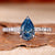 Blue stone ring with a pear-shaped design, perfect for elegant UK engagement styles.
