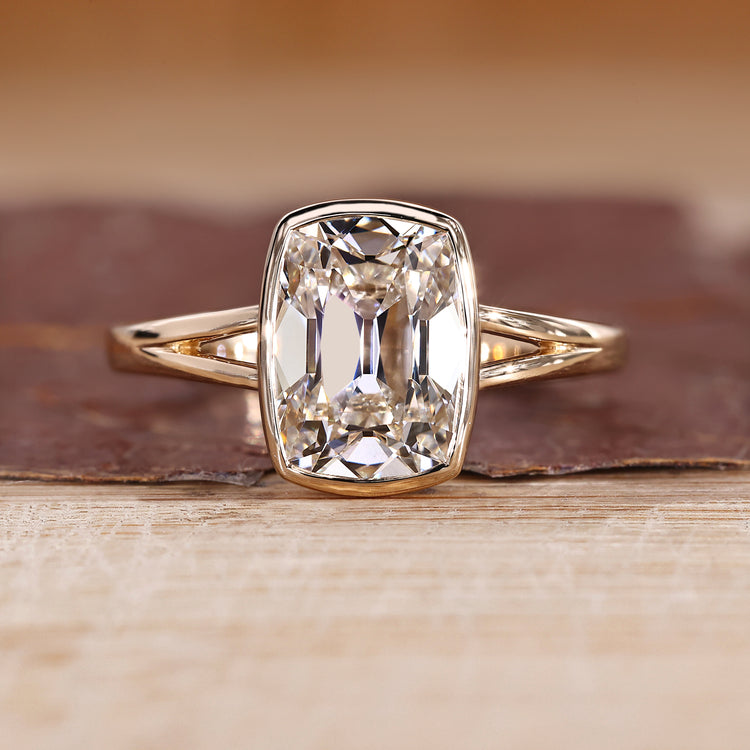 Bezel engagement ring with cushion old mine cut diamond solitaire style.