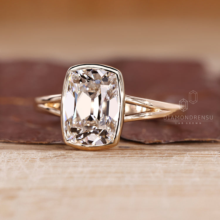 Lab grown cushion old mine cut diamond ring with split shank band.