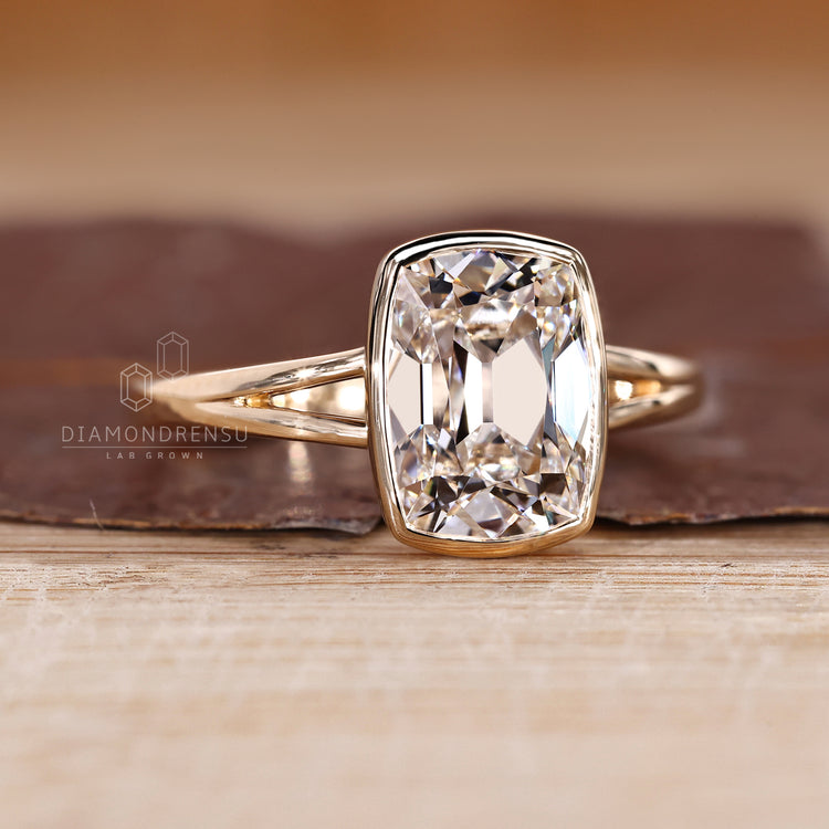 Cushion old mine cut diamond ring in solitaire style split shank band.