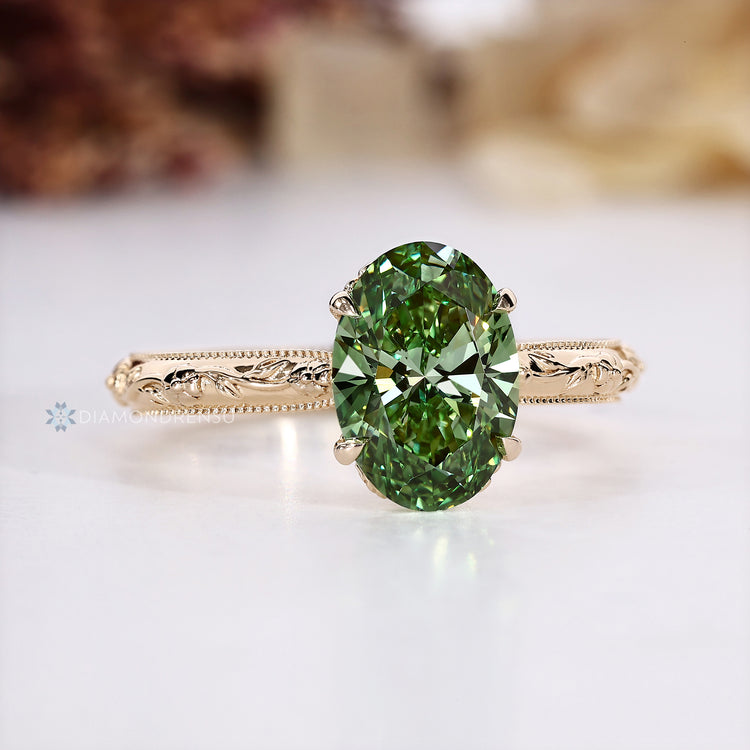 Green diamond solitaire ring with hidden bridge accent.