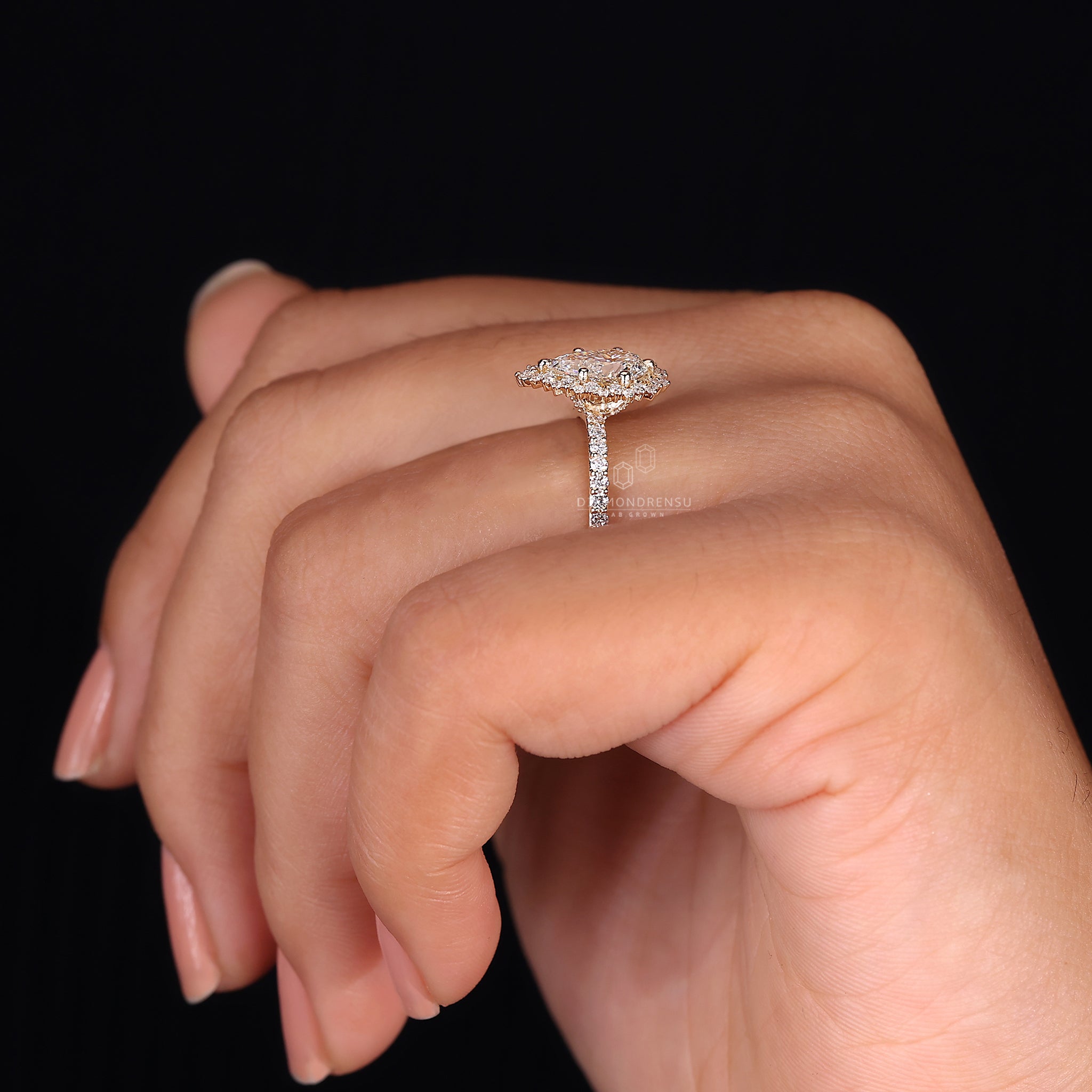 Yellow gold ring with round cut diamond and halo design.
