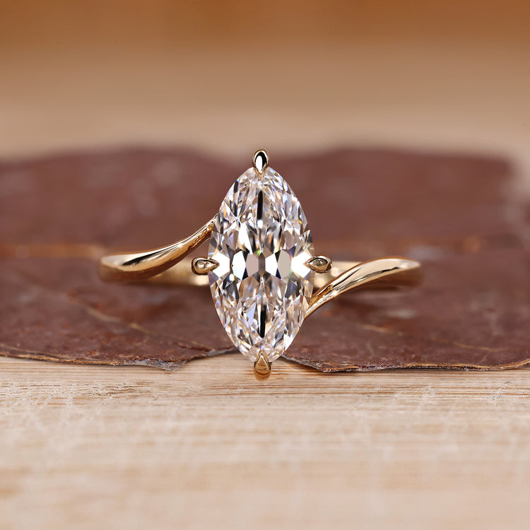 Solitaire engagement ring with marquise old european cut diamond bypass setting.