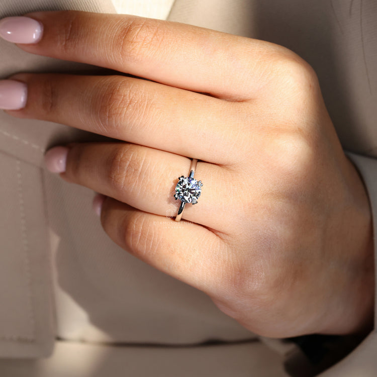 Round brilliant cut diamond ring in double claw prong setting.
