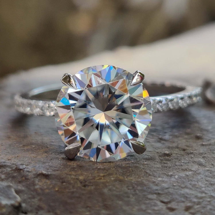 Round cut moissanite engagement ring in white gold.
