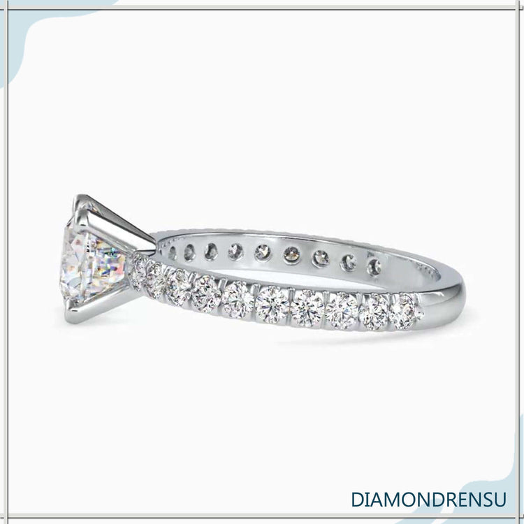 Cushion cut engagement ring with simple white gold band.
