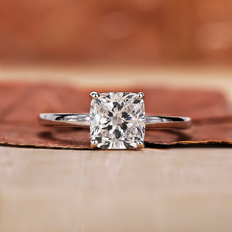 Cushion cut diamond ring with hidden halo engagement ring design.
