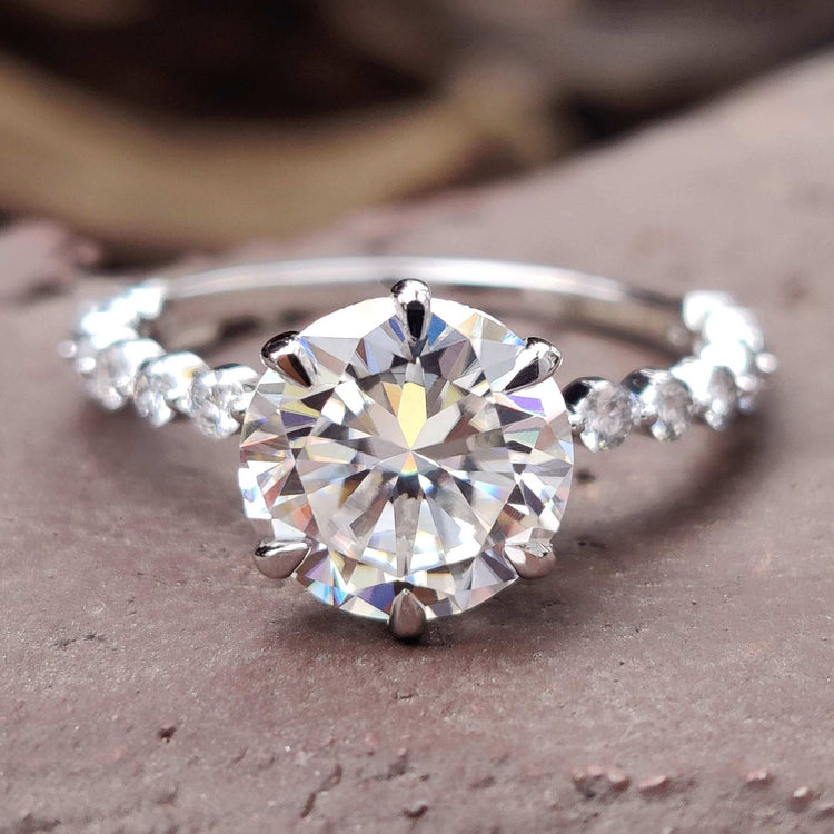 Round pave engagement ring with round cut moissanite centre stone.
