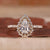 Pear cut diamond engagement ring set in yellow gold with fine detail.
