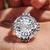 Portuguese cut ring with milgrain detail and round side stones in white gold.
